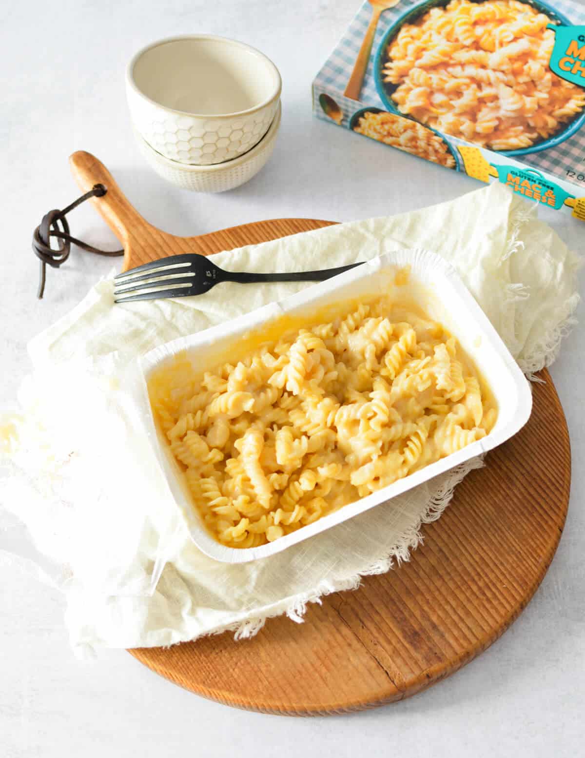 gluten free macaroni and cheese in a tray on a cutting board. 