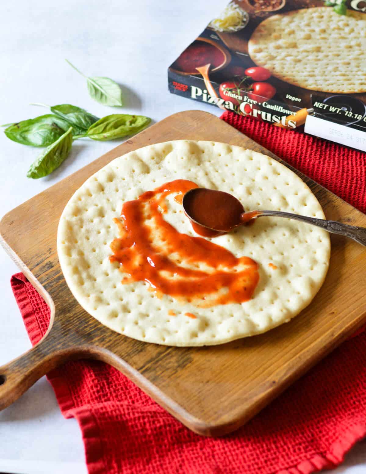 spoonful of pizza sauce on crust. 