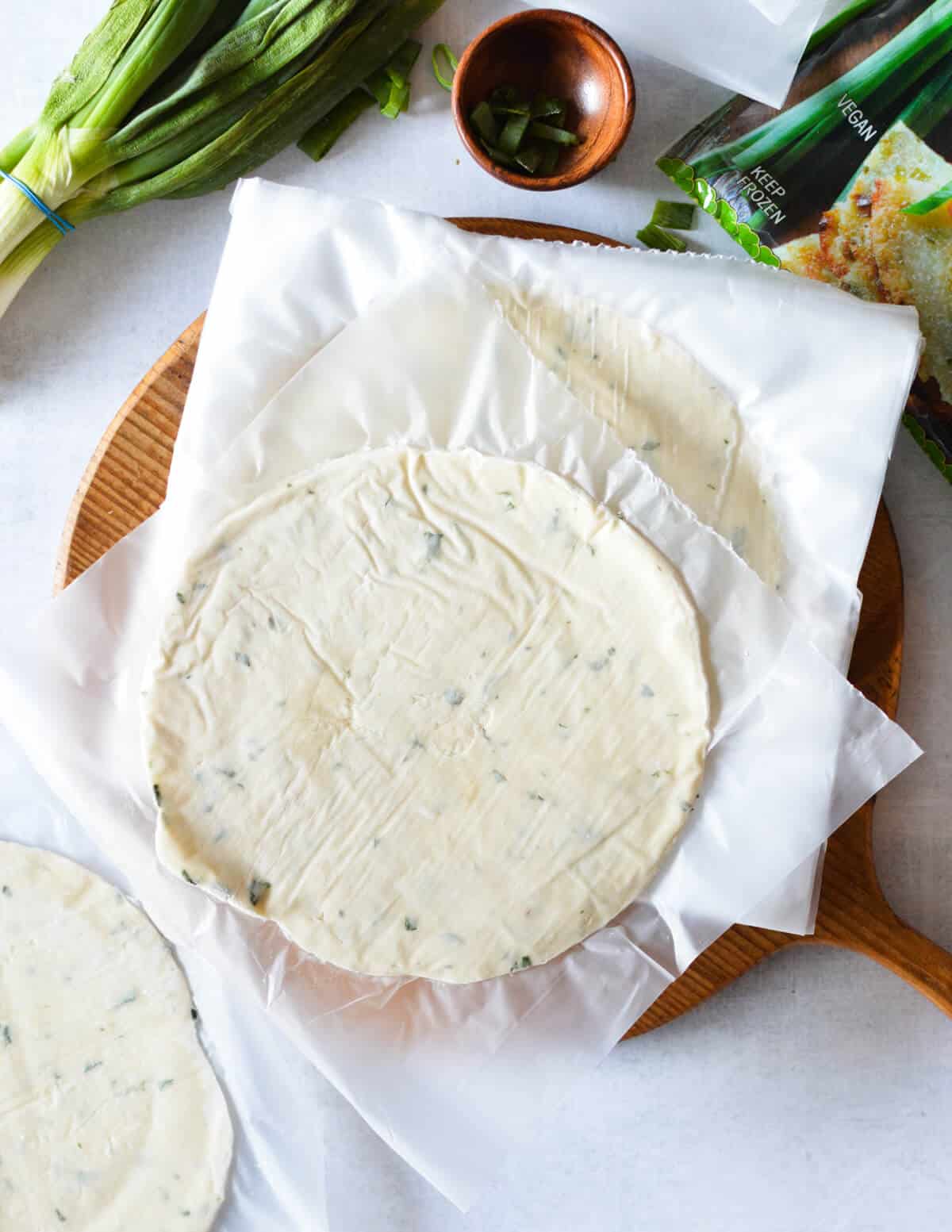 frozen taiwanese green onion pancakes on a cutting board.