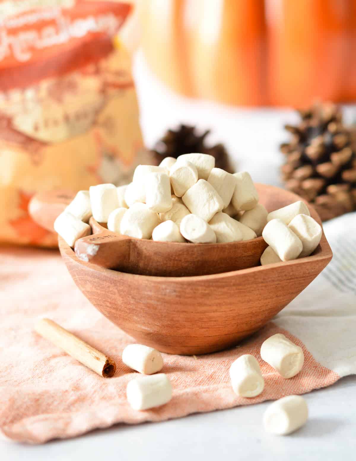 a wooden measuring cup of maple flavored marshmallows. 