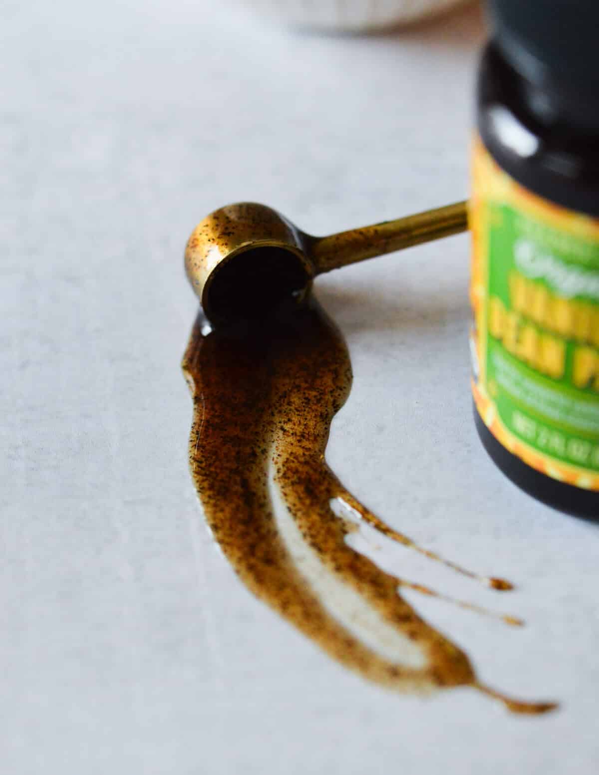 trader joes vanilla paste spilling out of a teaspoon. 